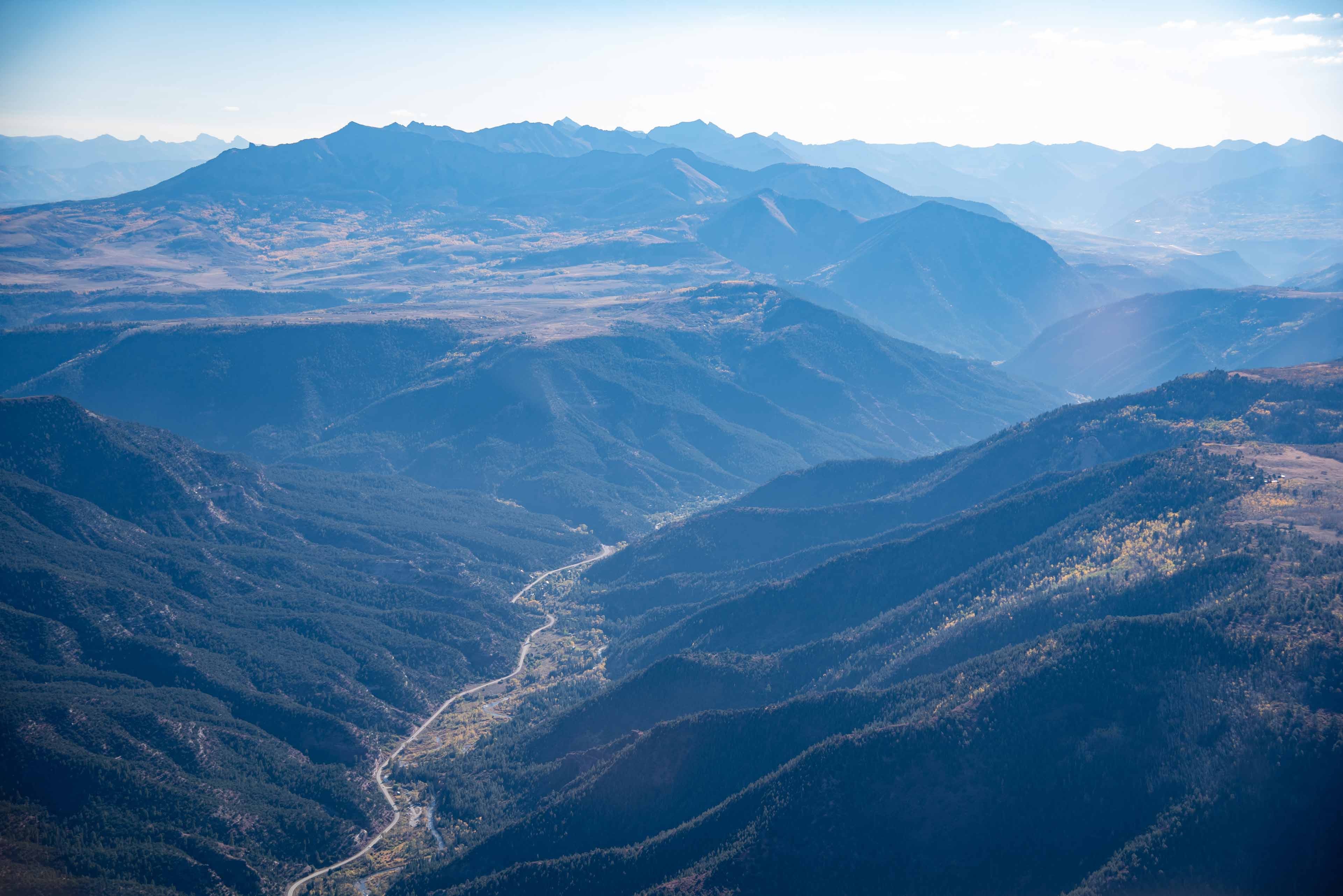 valley landscape with a road crossing alongside a river